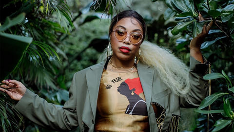 Maya Shipman / Suzi Analog in a jungle setting, facing the photographer